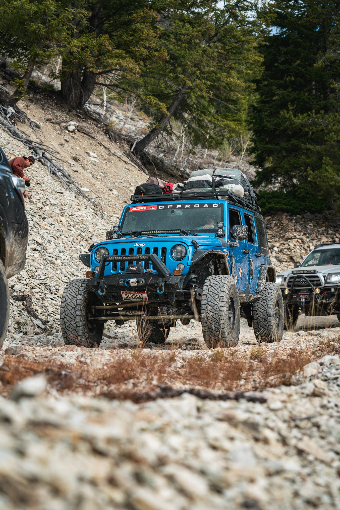Blue Jeep with "Apex Offroad" decal on windshield