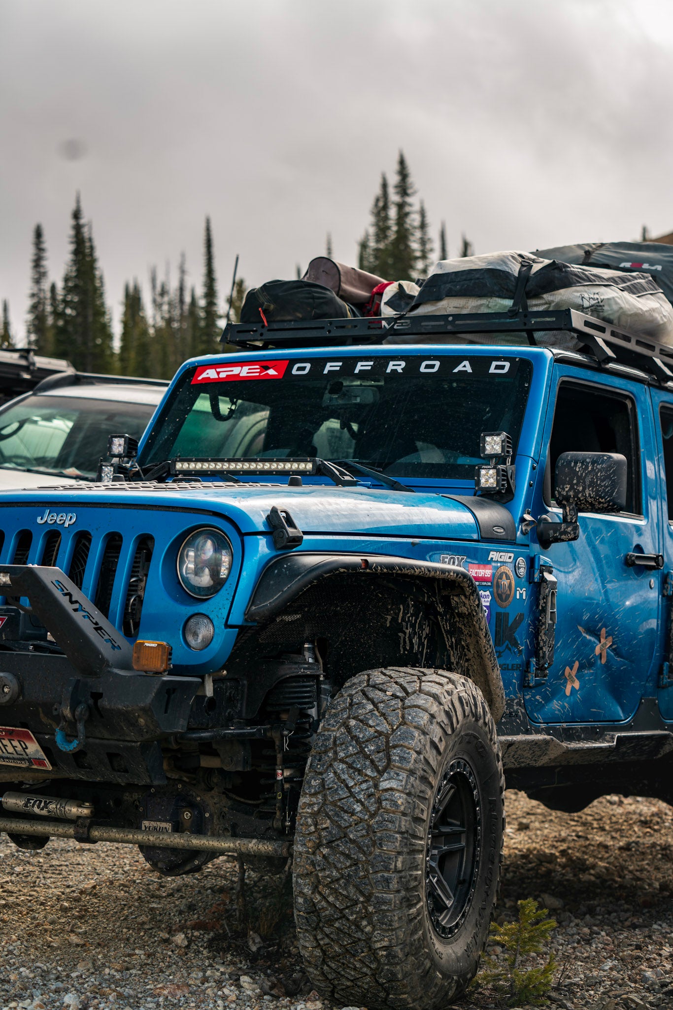 Blue Jeep with "Apex Offroad" decal on windshield