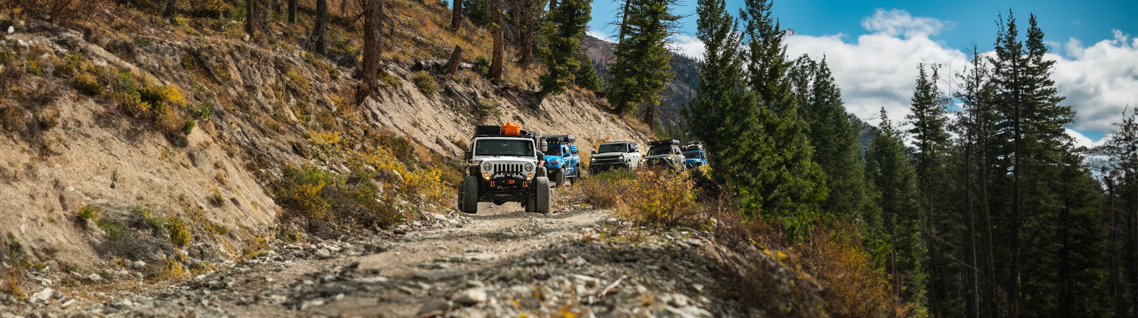 Trucks traversing challenging off-road terrain