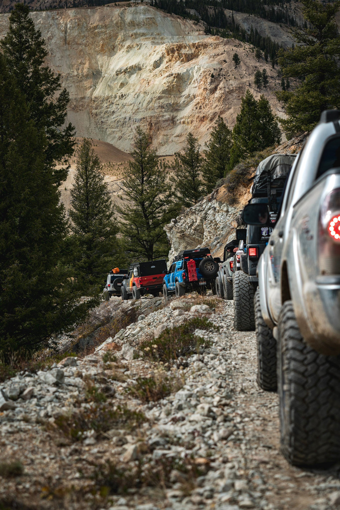 Convoy of trucks heading towards a campsite